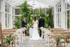 Couple standing with celebrant during an intimate glasshouse wedding in Kilrush, West Clare.