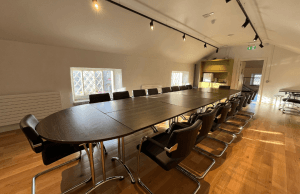 Image of the Stables conference room at Vandeleur Walled Garden and Visitor Centre. Large boardroom style table in a room filled with light.